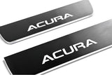 Close-up of white Acura lettering on reflective dark door sill plates.