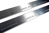 Close-up of Grandland X lettering and linear slots in silver-finished door sill plates.