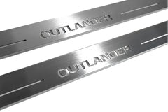 Close-up of Outlander lettering and linear slots in silver-finished door sill plates.