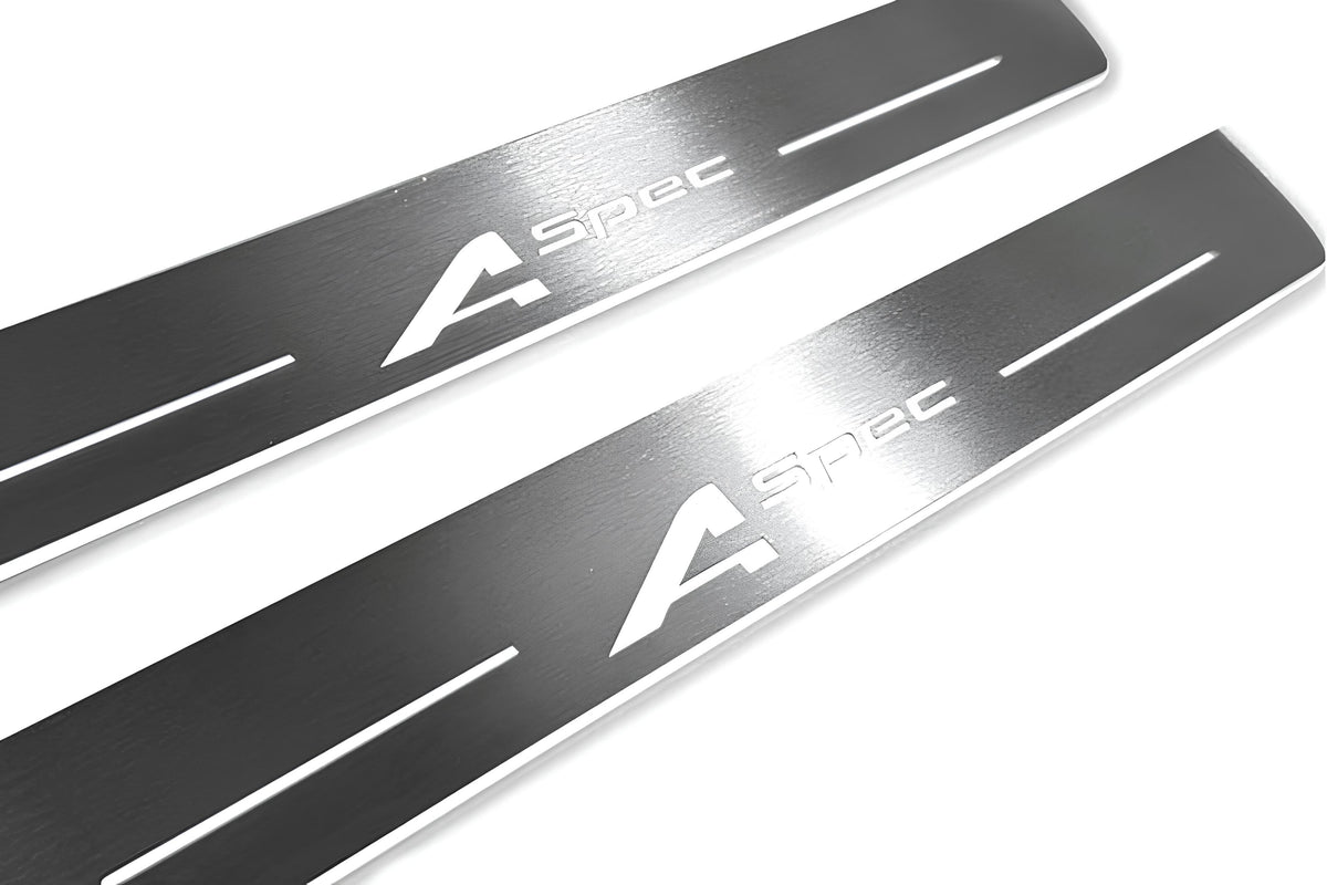Close-up of A-Spec lettering and linear slots in silver-finished door sill plates.
