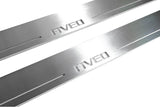 Close-up of Aveo lettering and linear slots in silver-finished door sill plates.