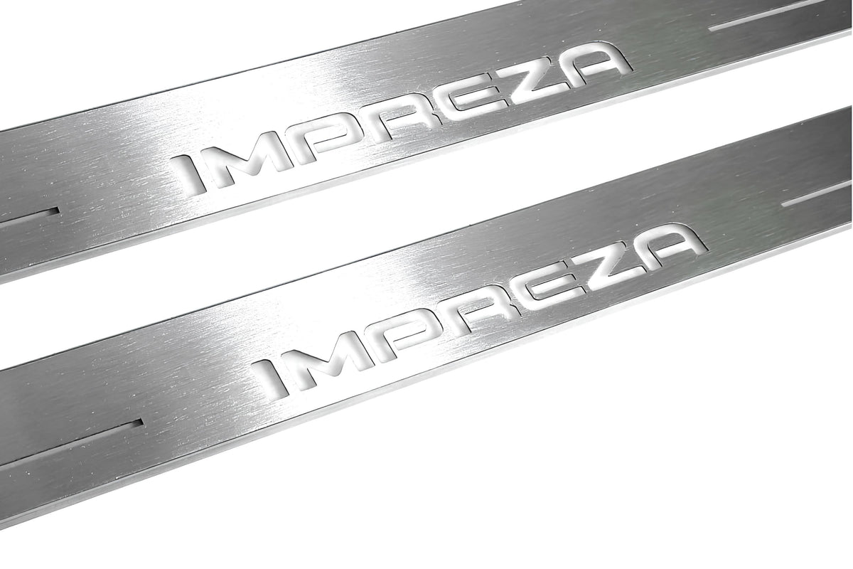 Close-up of Impreza lettering and linear slots in silver-finished door sill plates.