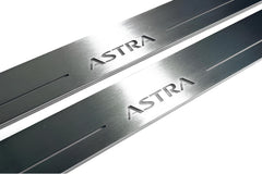 Close-up of Astra lettering and linear slots in silver-finished door sill plates.
