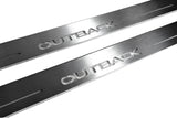 Close-up of Outback lettering and linear slots in silver-finished door sill plates.