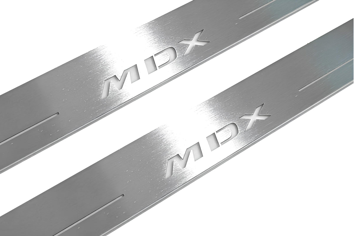 Close-up of MDX lettering and linear slots in silver-finished door sill plates.