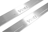 Close-up of Yeti lettering and linear slots in silver-finished door sill plates.