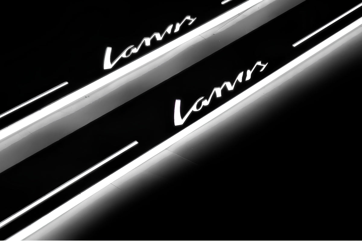 Close-up of Lanos lettering and illuminated edges on door sill plates against a dark background.