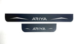 One long and one short reflective dark-finished Ariya door sill plate with angular graphics on a white background.