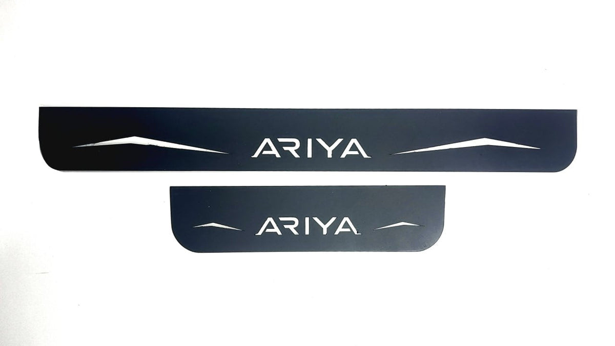 One long and one short reflective dark-finished Ariya door sill plate with angular graphics on a white background.