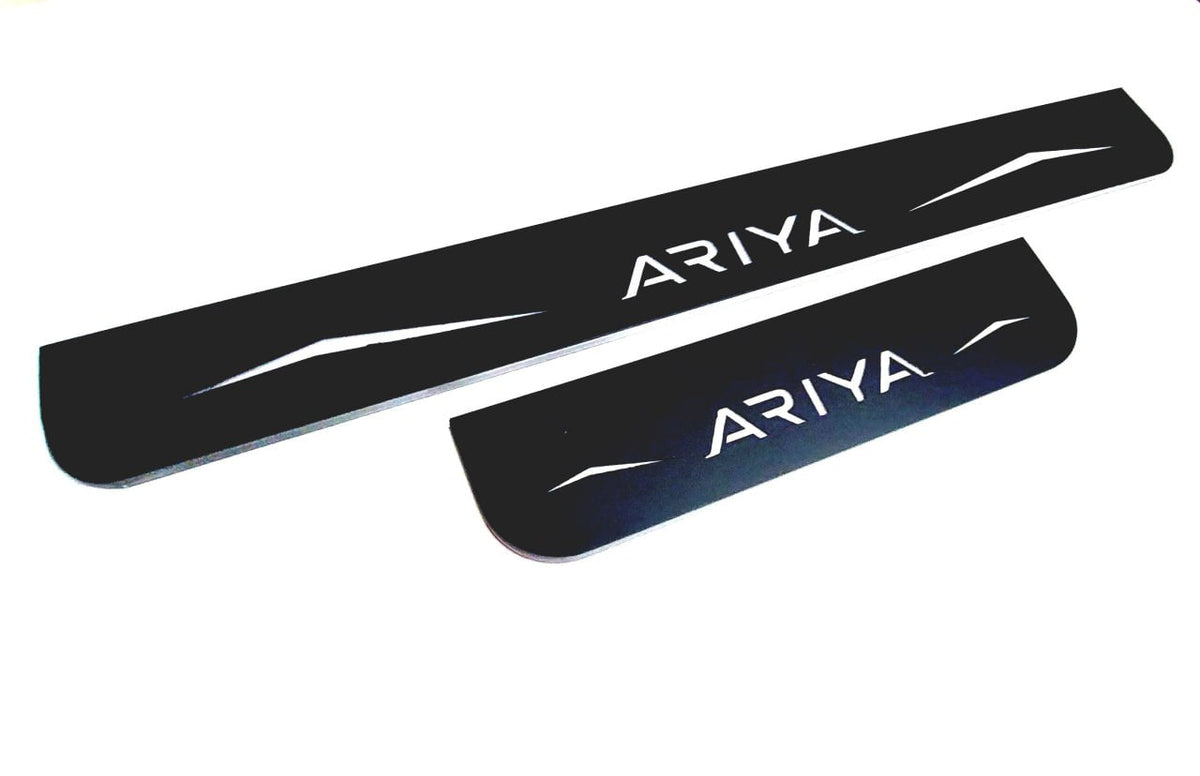 One long and one short reflective dark-finished Ariya door sill plate on a white background, angled view.