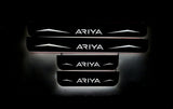 Four dark door sill plates with Ariya lettering, angular graphics and illuminated edges on a black background, straight-on view.