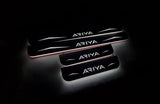 Four dark door sill plates with Ariya lettering, angular graphics and illuminated edges on a black background, angled view.