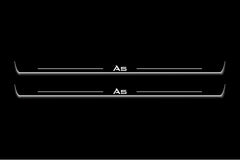 Two long door sill plates with A5 lettering and edges illuminated in white, straight-on view on a dark background.