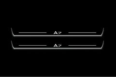 Two long door sill plates with A7 lettering and edges illuminated in white, straight-on view on a dark background.
