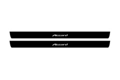 Catalog illustration of two black front door sill plates with Accord lettering.