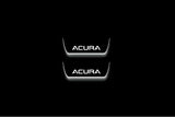 Two short door sill plates with Acura lettering and edges illuminated in white, straight-on view on a dark background.