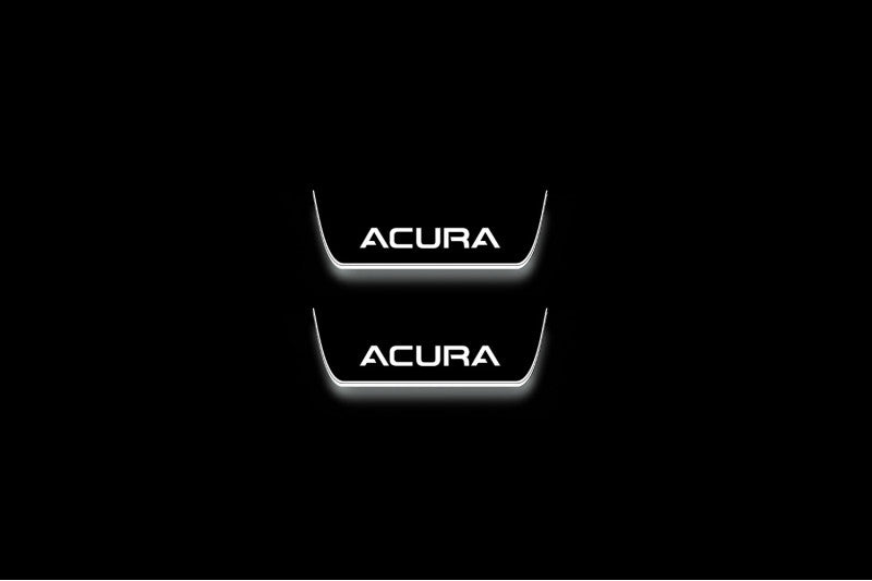 Two short door sill plates with Acura lettering and edges illuminated in white, straight-on view on a dark background.