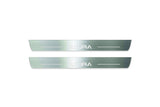 Two long silver-finished door sill plates with Acura lettering on a light background, straight-on view.