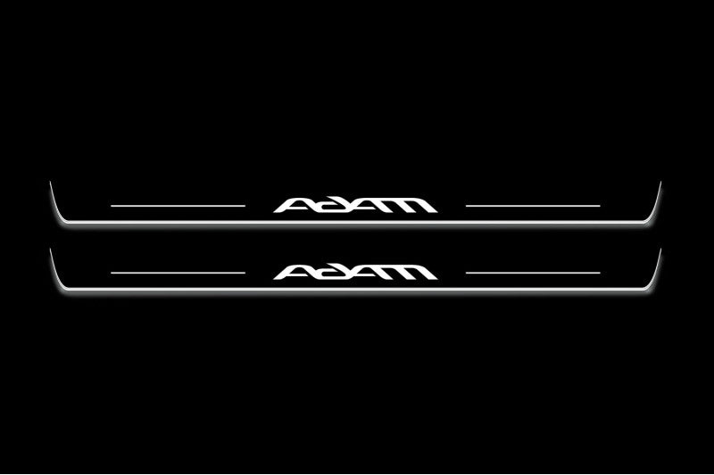 Two long door sill plates with Adam lettering and edges illuminated in white, straight-on view on a dark background.