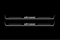 Two long door sill plates with allroad lettering and edges illuminated in white, straight-on view on a dark background.