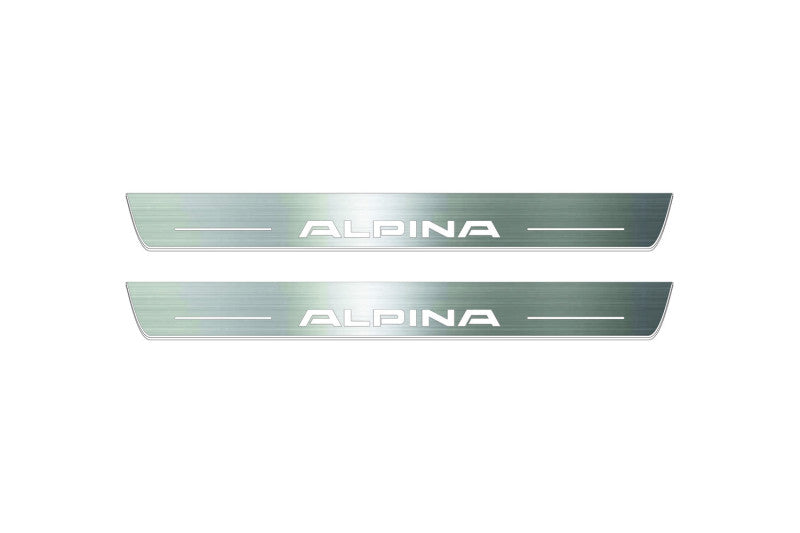 Two long silver-finished door sill plates with Alpina lettering on a light background, straight-on view.