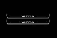 Two long door sill plates with Altima lettering and edges illuminated in white, straight-on view on a dark background.