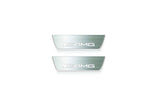Two short silver-finished door sill plates with AMG lettering on a light background, straight-on view.