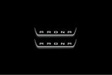 Two short door sill plates with Arona lettering and edges illuminated in white, straight-on view on a dark background.