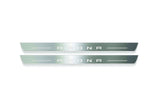 Two long silver-finished door sill plates with Arona lettering on a light background, straight-on view.