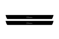 Catalog illustration of two black front door sill plates with Cadillac lettering.