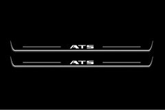 Two long door sill plates with ATS lettering and edges illuminated in white, straight-on view on a dark background.