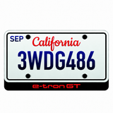 Audi e-tron GT illuminated LED badge beneath an illustrative US license plate; plate not included