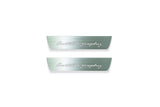 Two short silver-finished door sill plates with Autobiography lettering on a light background, straight-on view.