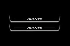 Two long door sill plates with Avante lettering and edges illuminated in white, straight-on view on a dark background.