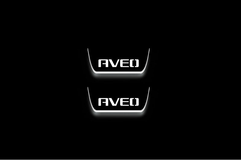 Two short door sill plates with Aveo lettering and edges illuminated in white, straight-on view on a dark background.
