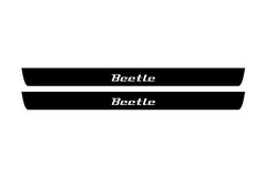 Catalog illustration of two black front door sill plates with Beetle lettering.