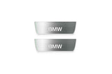 Two short silver-finished door sill plates with BMW lettering on a light background, straight-on view.
