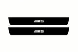 Catalogue illustration of two front black Matte PRO LED door sill plates with illuminated M5 lettering for BMW 5 E61; dimensions are selected during manufacture.