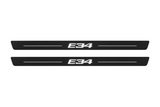 Matte PRO catalogue illustration showing two FRONT plates with illuminated E34 lettering on a white background; BMW 5 Series Sedan E34 dimensions are selected during manufacture; rear plates are not pictured.