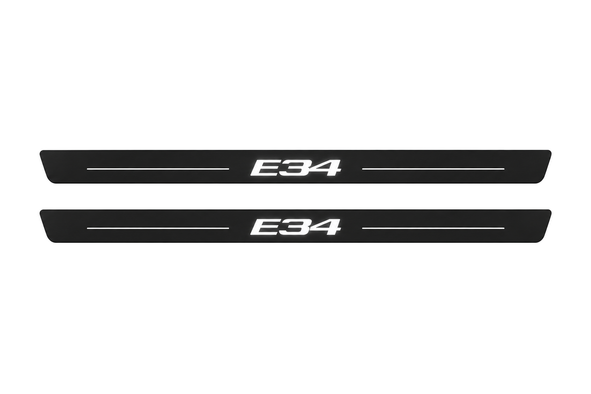 Matte PRO catalogue illustration showing two FRONT plates with illuminated E34 lettering on a white background; BMW 5 Series Sedan E34 dimensions are selected during manufacture; rear plates are not pictured.