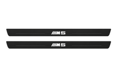 Matte PRO catalogue illustration showing two FRONT plates with illuminated M5 lettering on a white background; BMW 5 Series Sedan E34 dimensions are selected during manufacture; rear plates are not pictured.