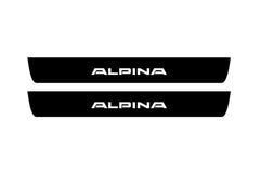 Catalog illustration of two black front door sill plates with Alpina lettering.
