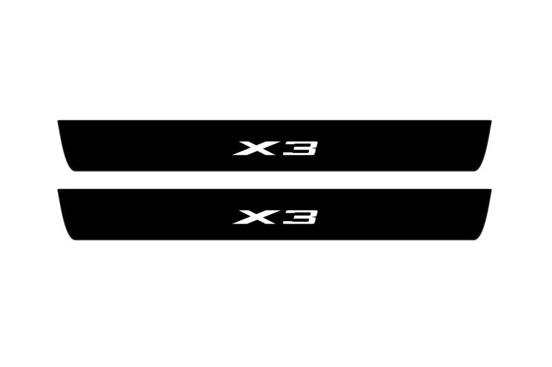 Catalog illustration of two black front door sill plates with X3 lettering.