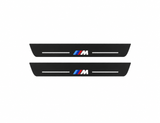 BMW X3 F25 black matte LED door sills with M Type 3 design on white background