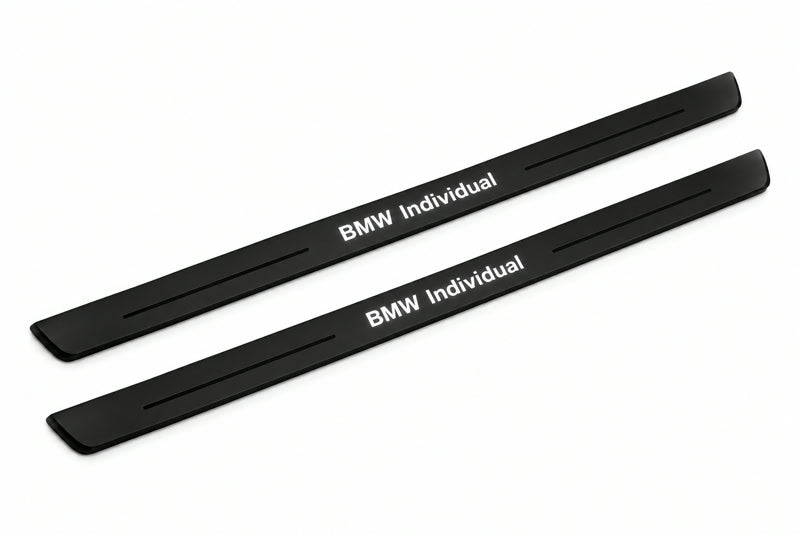 Catalogue illustration of two front black Matte PRO LED door sill plates with illuminated BMW Individual lettering for BMW X5 E53; dimensions are selected during manufacture.