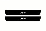 Catalogue illustration of two front black Matte PRO LED door sill plates with illuminated X7 lettering for BMW X7 G07; dimensions are selected during manufacture.
