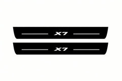 Catalogue illustration of two front black Matte PRO LED door sill plates with illuminated X7 lettering for BMW X7 G07; dimensions are selected during manufacture.