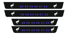 Catalog illustration of four black door sill plates with blue Bronco lettering and white bucking horse emblems.