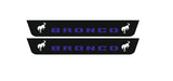 Catalog illustration of two short black door sill plates with blue Bronco lettering and white bucking horse emblems.