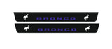 Catalog illustration of two long black door sill plates with blue Bronco lettering and white bucking horse emblems.